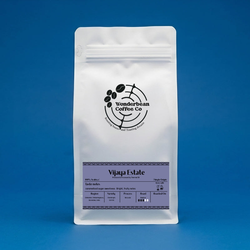 White Wonderbean Vijaya Estate Arabica Naturals coffee pouch against a blue background