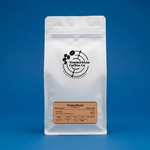 White Wonderbean Vienna Roast coffee pouch against a blue background
